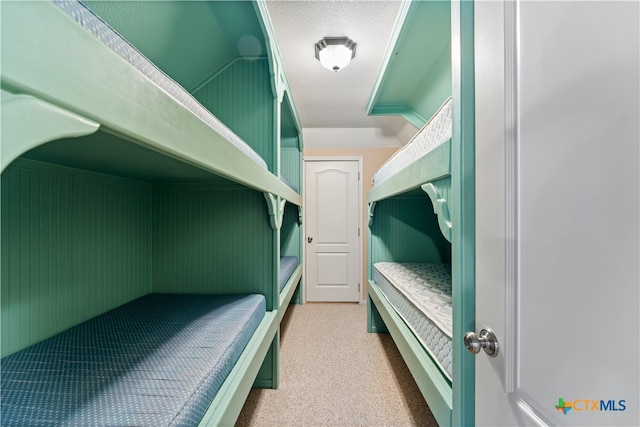 bedroom featuring lofted ceiling and light carpet