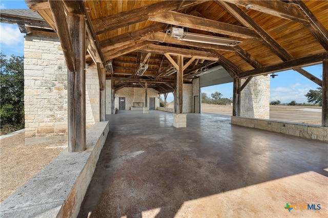 exterior space with vaulted ceiling with beams and wooden ceiling