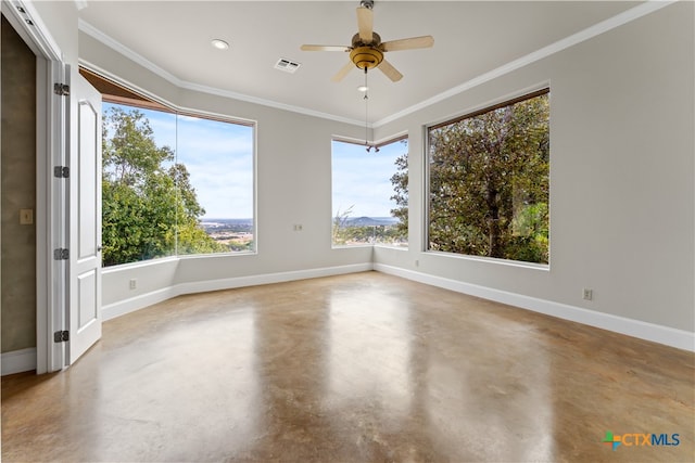 unfurnished room with ceiling fan, concrete floors, ornamental molding, and plenty of natural light