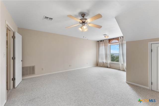 carpeted spare room with lofted ceiling and ceiling fan