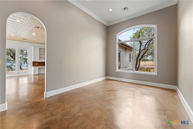 unfurnished room featuring ornamental molding and concrete flooring