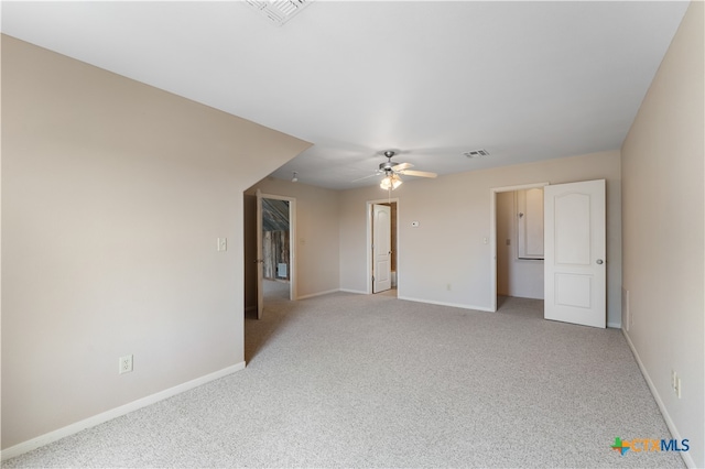 carpeted spare room featuring ceiling fan