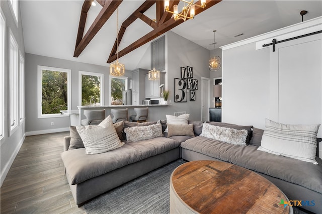 living room featuring wood-type flooring, a notable chandelier, a barn door, high vaulted ceiling, and beamed ceiling