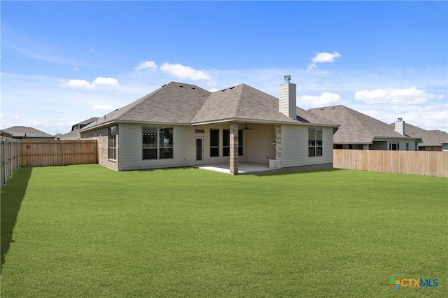 7912 Emery Oaks Dr, Temple, TX 76502 - rear view of house with a chimney, a shingled roof, a fenced backyard, a yard, and a patio area