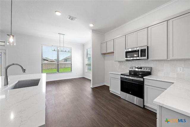 7912 Emery Oaks Dr, Temple, TX 76502 - kitchen featuring light stone countertops, stainless steel appliances, visible vents, and a sink