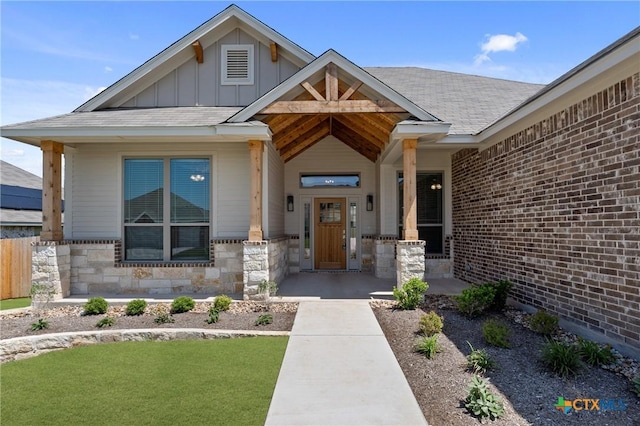 7912 Emery Oaks Dr, Temple, TX 76502 - property entrance with a yard, board and batten siding, a porch, and stone siding
