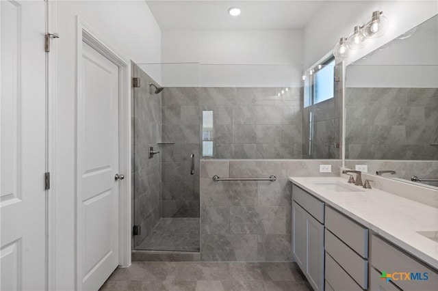 7912 Emery Oaks Dr, Temple, TX 76502 - full bathroom featuring double vanity, a sink, tile walls, tile patterned floors, and a shower stall