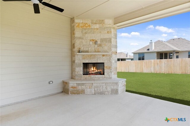 7912 Emery Oaks Dr, Temple, TX 76502 - view of patio / terrace with fence, an outdoor stone fireplace, and a ceiling fan
