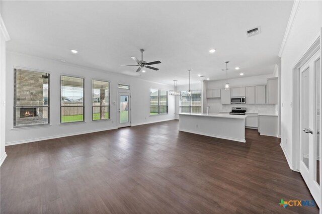 7912 Emery Oaks Dr, Temple, TX 76502 - unfurnished living room featuring a sink, visible vents, ceiling fan, ornamental molding, and dark wood-style floors