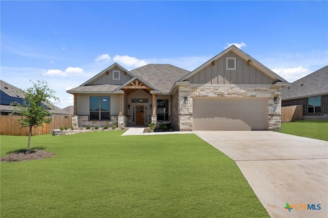7912 Emery Oaks Dr, Temple, TX 76502 - craftsman-style house with stone siding, an attached garage, fence, board and batten siding, and a front yard