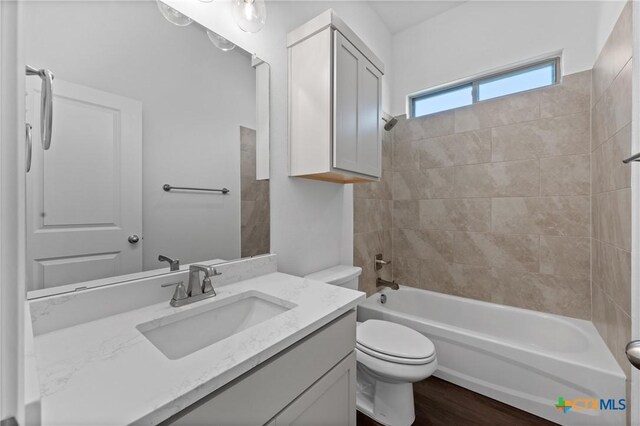 7912 Emery Oaks Dr, Temple, TX 76502 - bathroom with toilet, washtub / shower combination, vanity, and wood finished floors