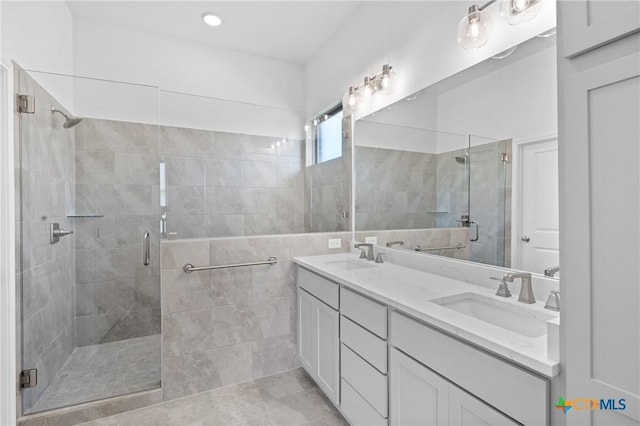 7912 Emery Oaks Dr, Temple, TX 76502 - full bath with a shower stall, tile walls, double vanity, and a sink