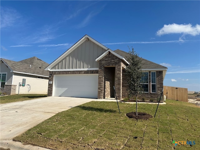 view of front of property featuring a garage and a front yard