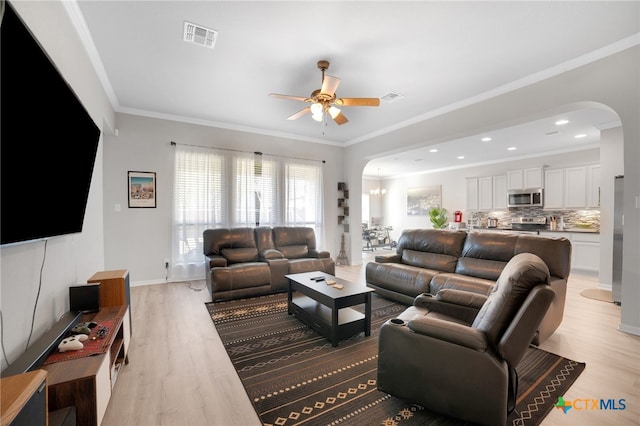 1444 Rolling Brook Dr, Temple, TX 76502 - living room with arched walkways, ceiling fan, light wood-type flooring, ornamental molding, and baseboards