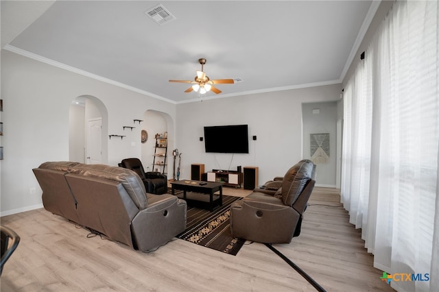 1444 Rolling Brook Dr, Temple, TX 76502 - living room with arched walkways, wood finished floors, ceiling fan, baseboards, and crown molding