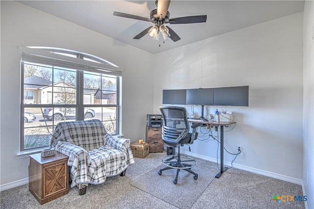 carpeted home office featuring ceiling fan