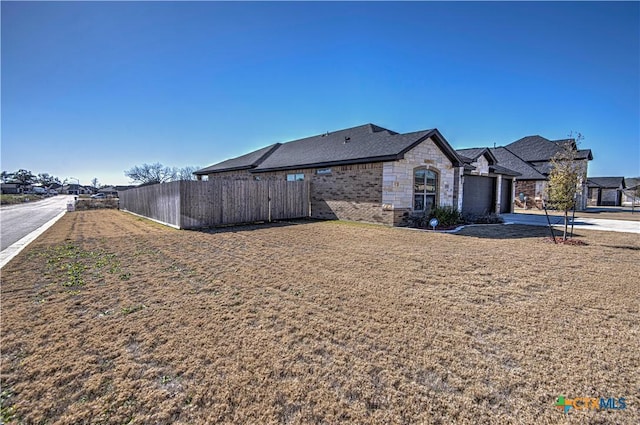 exterior space with a garage and a lawn