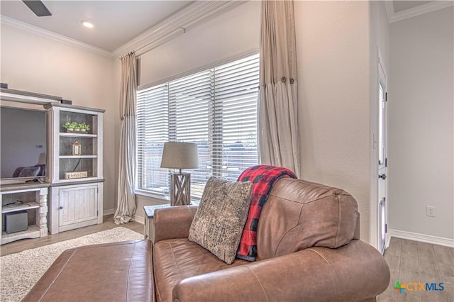 living room with ornamental molding and light wood-type flooring