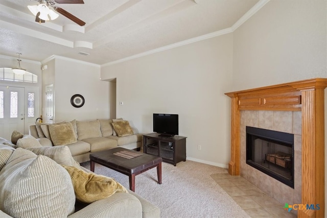 carpeted living room with a fireplace, ceiling fan, and ornamental molding