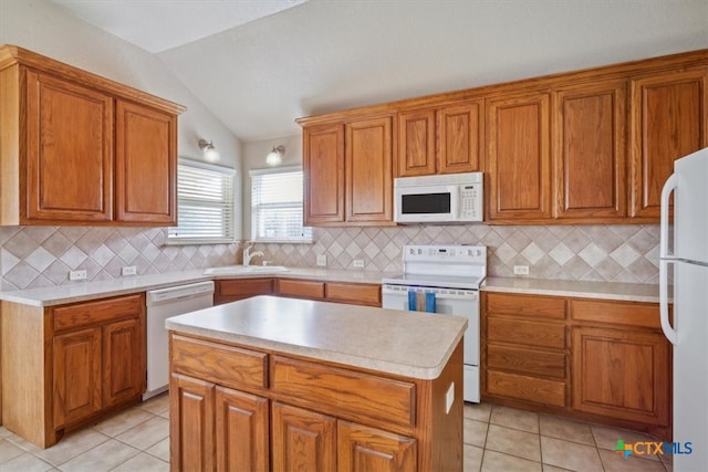 kitchen featuring a kitchen island, decorative backsplash, vaulted ceiling, sink, and white appliances