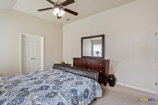 bedroom with light colored carpet, lofted ceiling, ceiling fan, and a closet