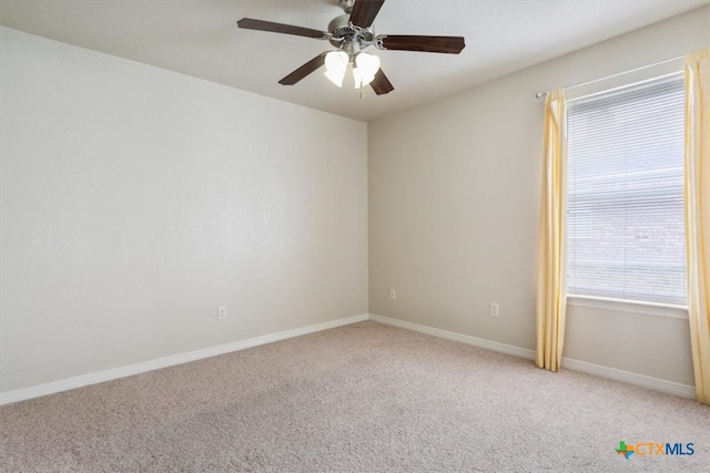 carpeted spare room with ceiling fan