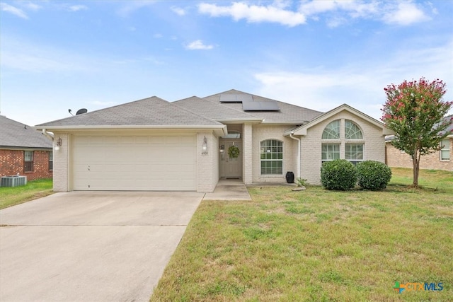 single story home featuring central air condition unit, a garage, and a front yard