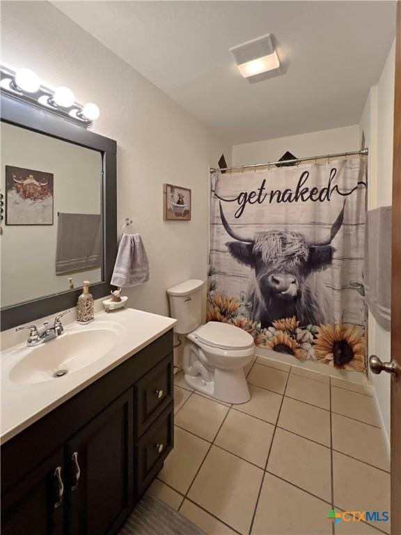 701 Clark St, Gonzales, TX 78629 - full bathroom with vanity, toilet, tile patterned flooring, and a shower with curtain