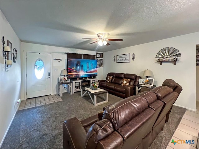 701 Clark St, Gonzales, TX 78629 - tiled living room featuring ceiling fan, baseboards, and a textured ceiling