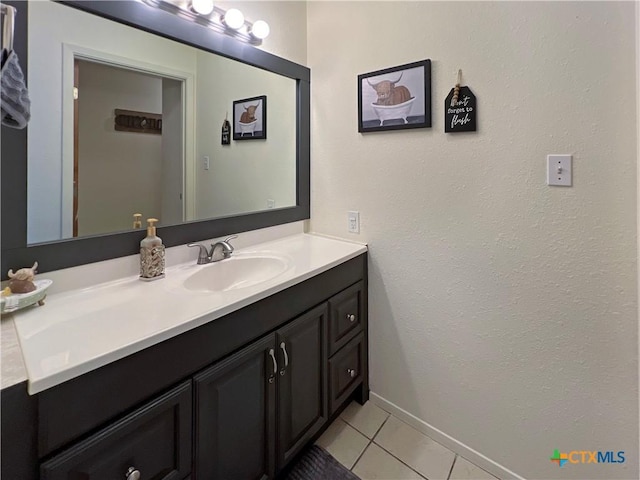 701 Clark St, Gonzales, TX 78629 - bathroom featuring vanity, tile patterned floors, and baseboards