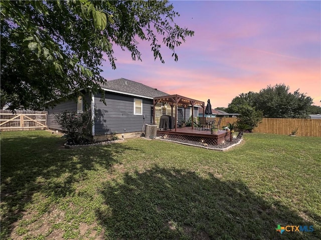 701 Clark St, Gonzales, TX 78629 - back of house at dusk with a deck and a pergola