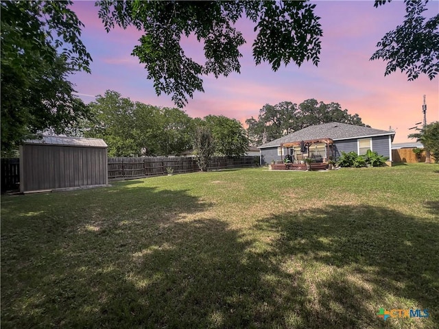 701 Clark St, Gonzales, TX 78629 - yard at dusk featuring a wooden deck