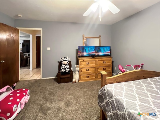 701 Clark St, Gonzales, TX 78629 - carpeted bedroom featuring ceiling fan and tile patterned floors