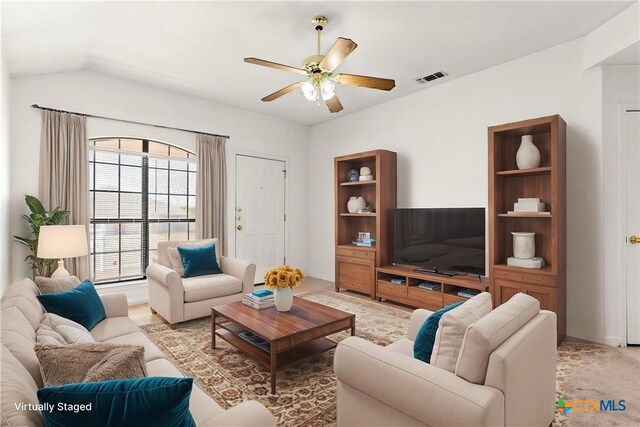 spare room featuring ceiling fan, lofted ceiling, and light colored carpet