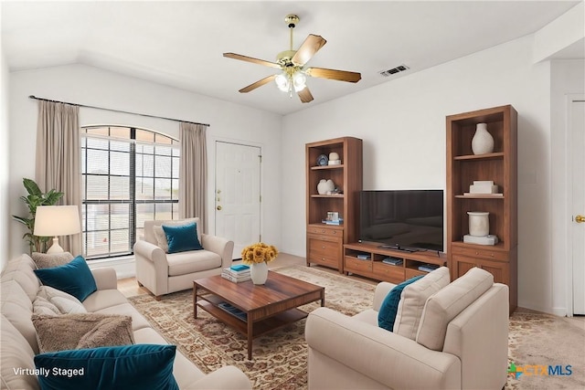 carpeted living room with ceiling fan and vaulted ceiling