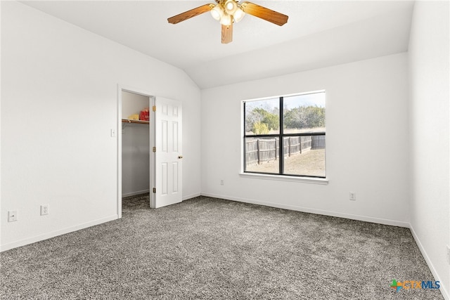 unfurnished bedroom featuring ceiling fan, a closet, lofted ceiling, and carpet flooring