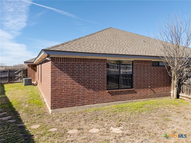 view of property exterior with cooling unit and a lawn