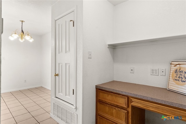 interior space with light tile patterned floors and a notable chandelier