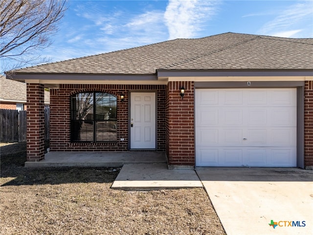 view of front of property featuring concrete driveway, brick siding, and roof with shingles