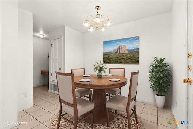 dining space with a notable chandelier and light tile patterned flooring