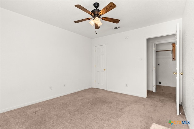 unfurnished bedroom with ceiling fan and light carpet