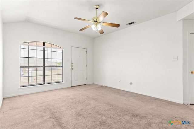 carpeted empty room featuring ceiling fan and lofted ceiling