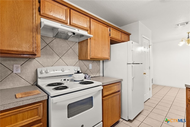 kitchen with decorative light fixtures, backsplash, an inviting chandelier, white appliances, and light tile patterned floors