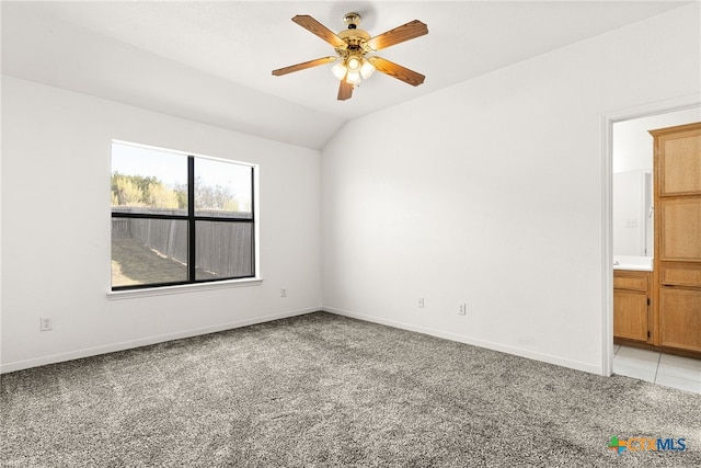 carpeted empty room featuring lofted ceiling and ceiling fan