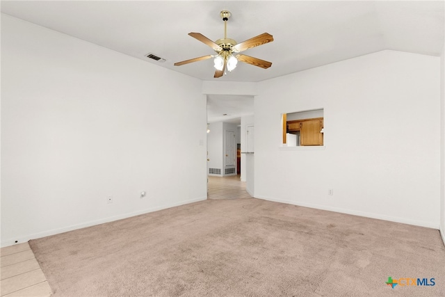 carpeted spare room featuring ceiling fan