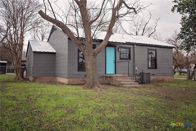 view of front facade with central AC unit and a front lawn