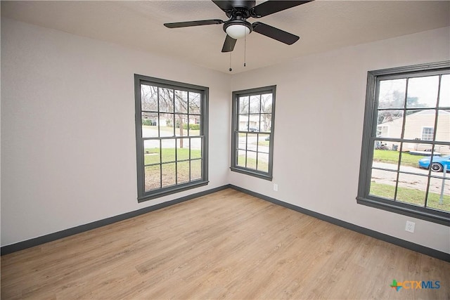 unfurnished room with ceiling fan and light hardwood / wood-style floors