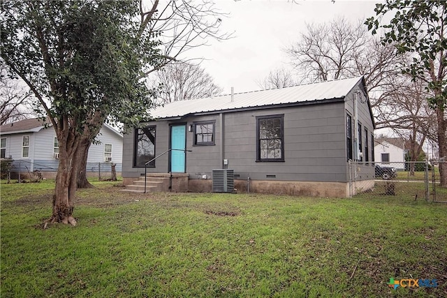 view of front of home with central AC and a front lawn