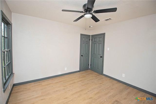 spare room featuring ceiling fan and light wood-type flooring