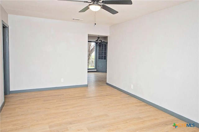 empty room featuring ceiling fan and light hardwood / wood-style flooring